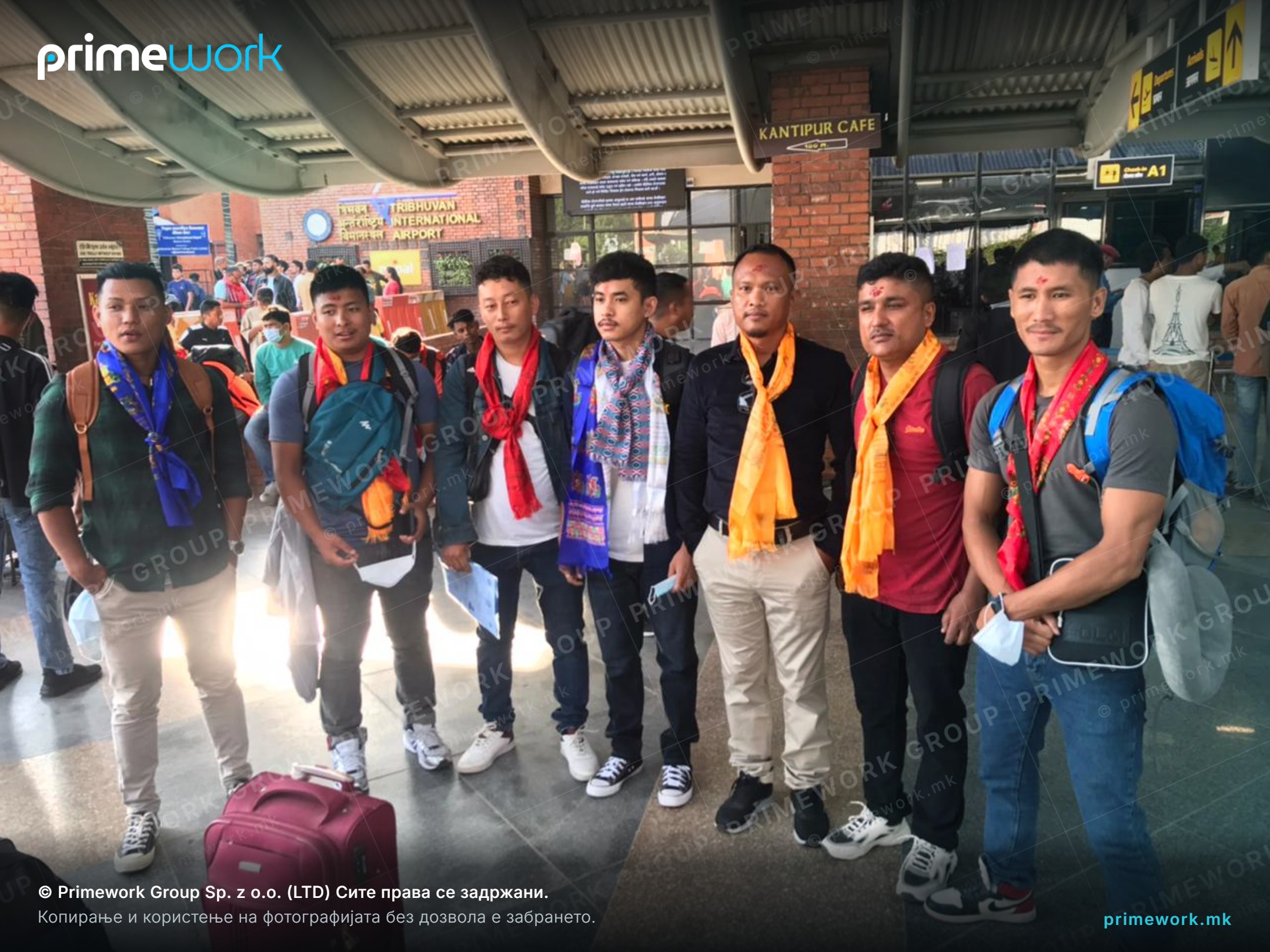 Nepali workers with backpacks checking in luggage at the airport