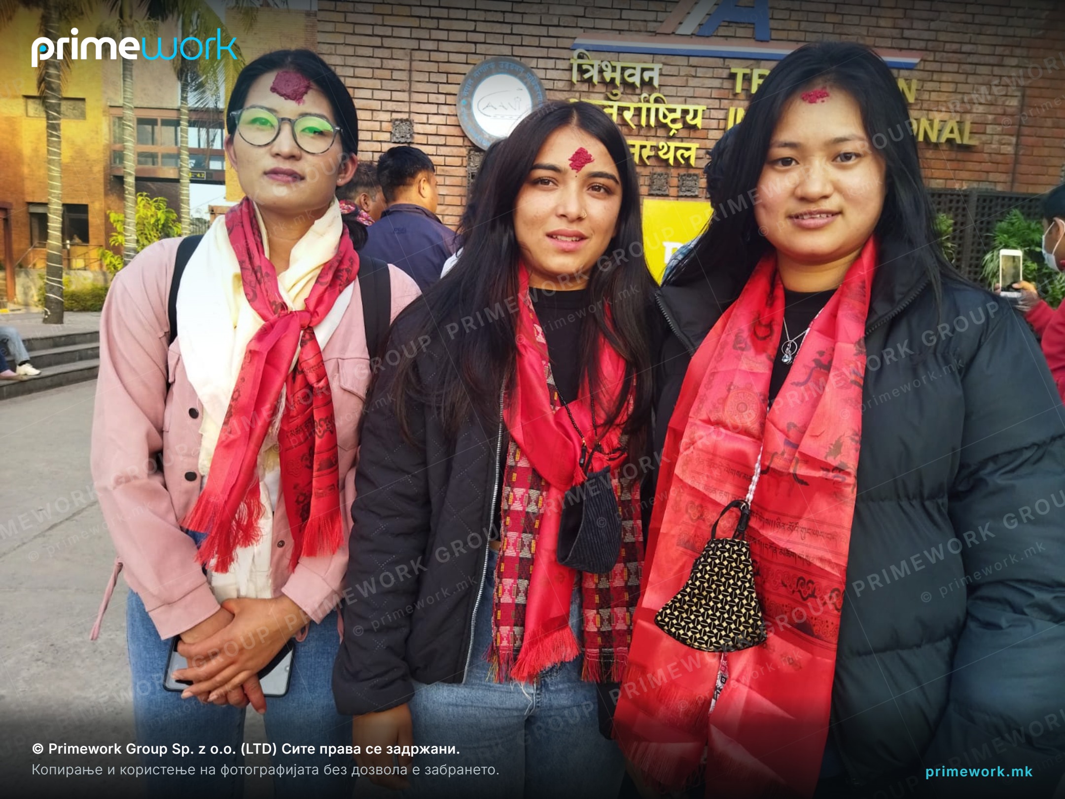 Female workers from Nepal in front of the international airport building