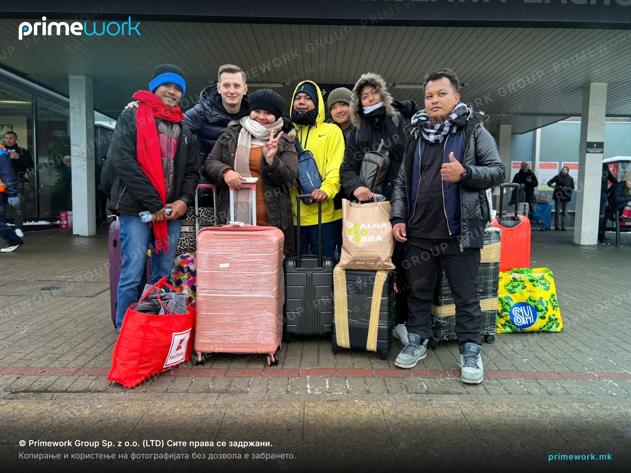A group of Filipino workers with suitcases right after arriving at a railway station