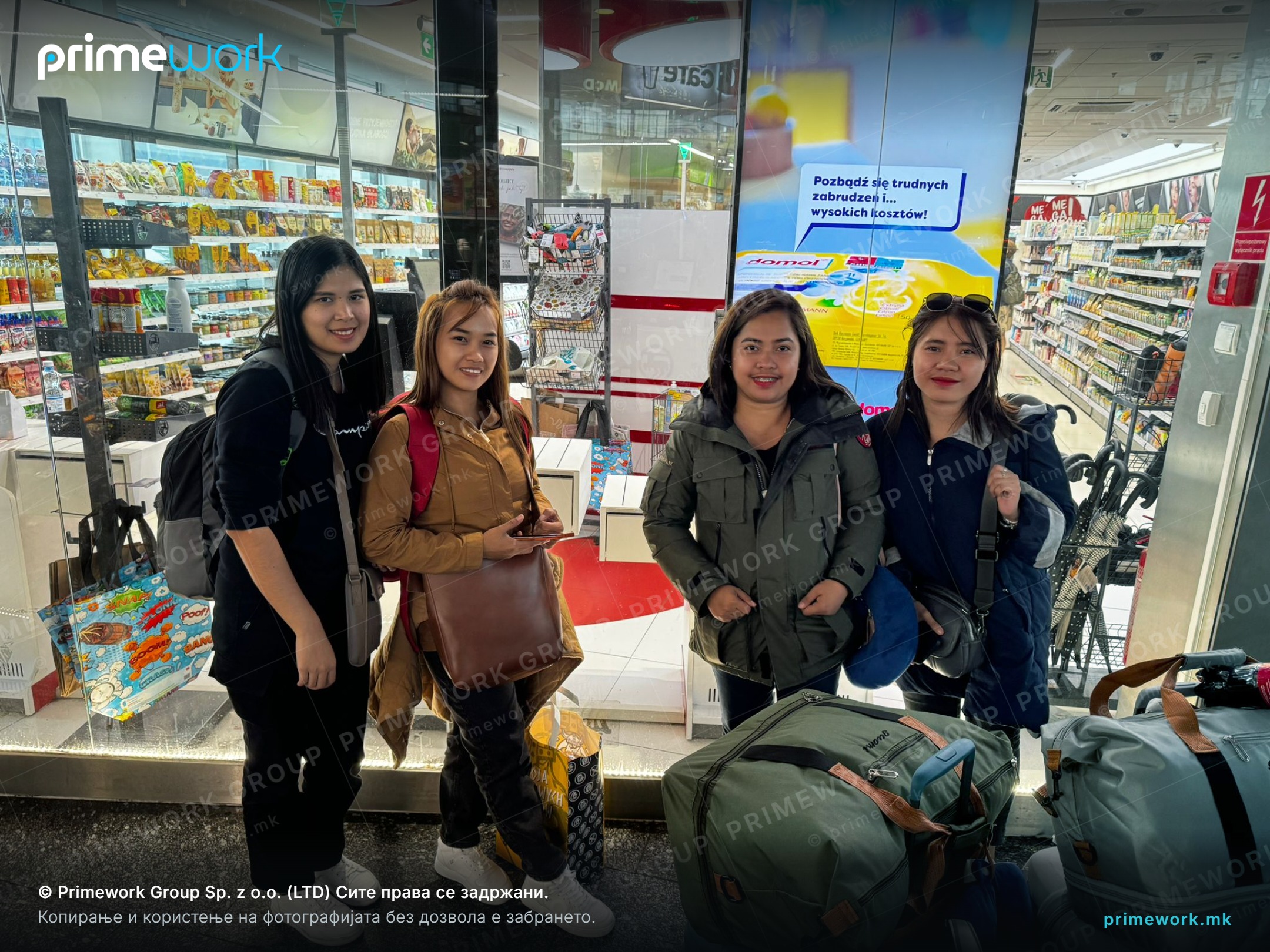 Female workers from Asia with luggage at a station during transfer to their accommodation