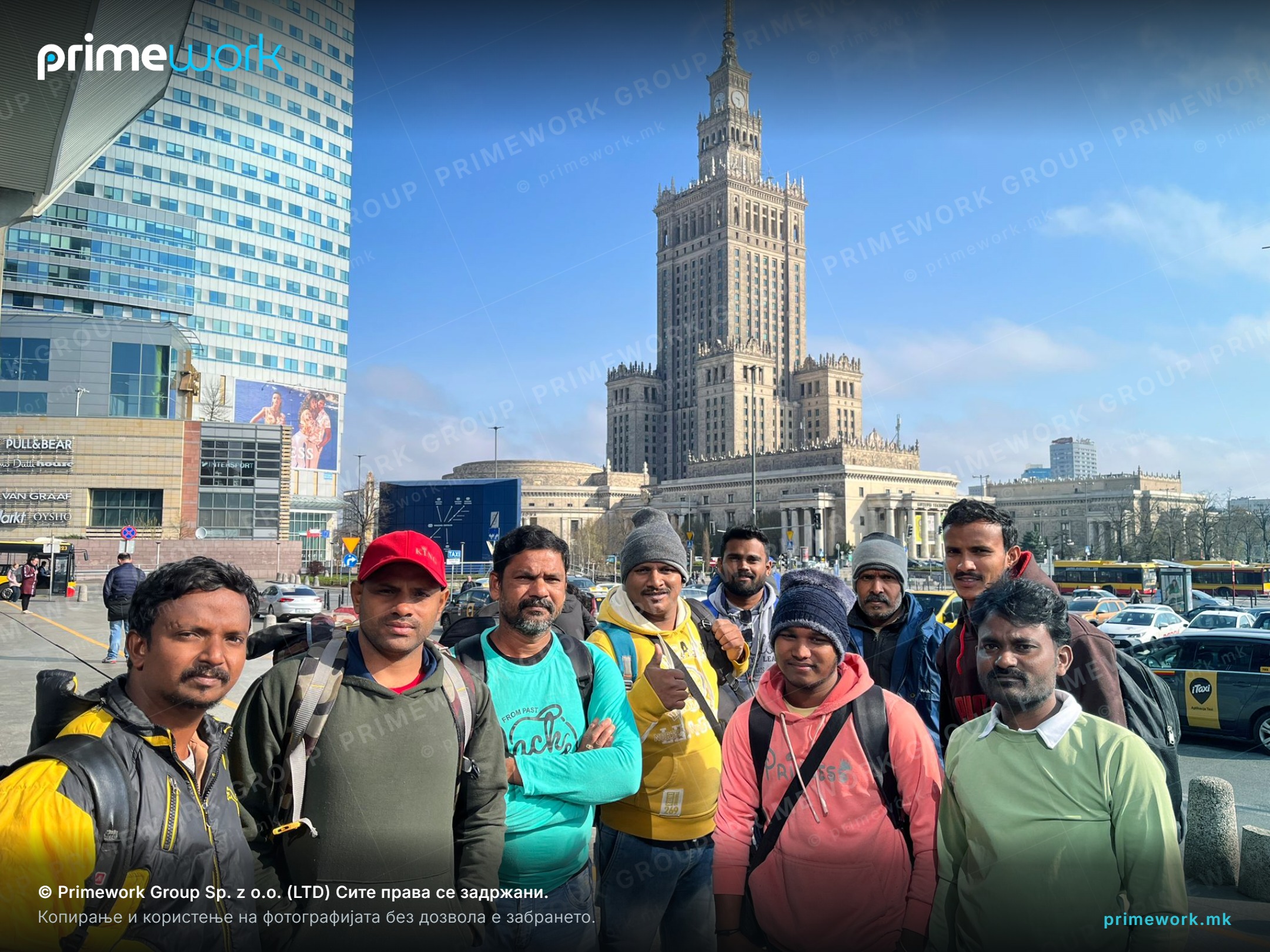 A team of Indian workers outdoors in the city after arrival