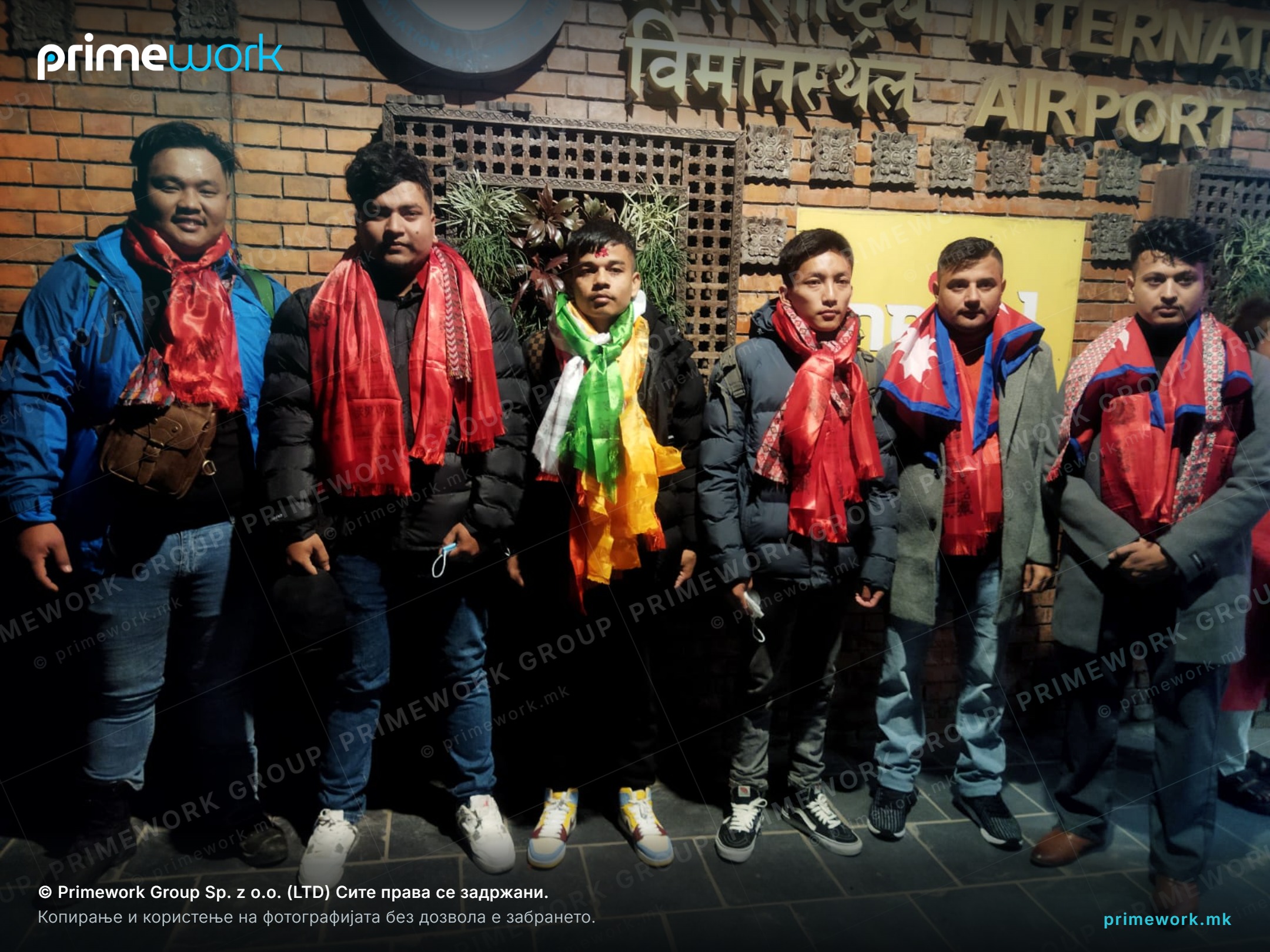 Nepali workers being seen off with traditional scarves outside the airport